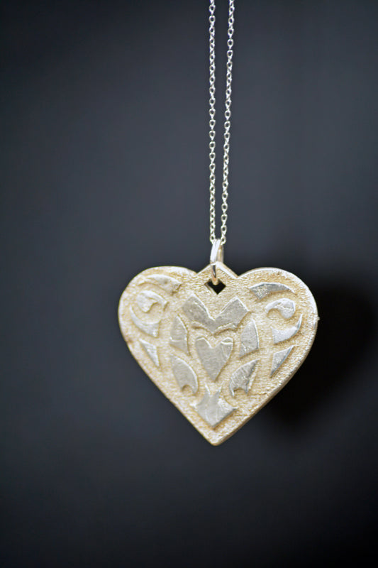 Handcrafted Sterling Silver Heart Pendant with Raised Pattern Design