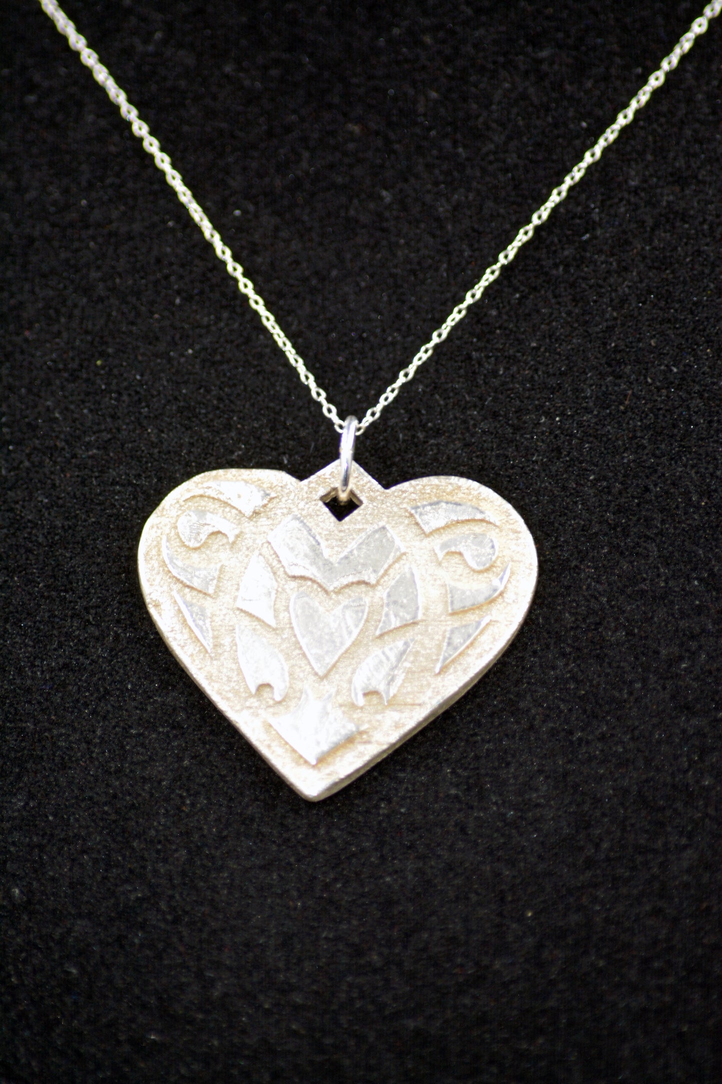 Handcrafted Sterling Silver Heart Pendant with Raised Pattern Design